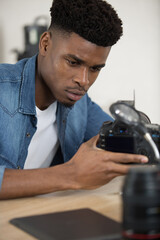 young man repairing motherboard from pc