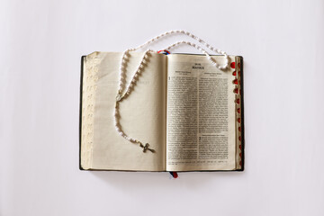 The Bible and Rosary Photographed from the Top View in an Isolated Background