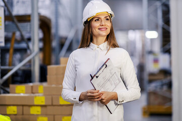 Technology engineer is looking around factory storage and inventorying.