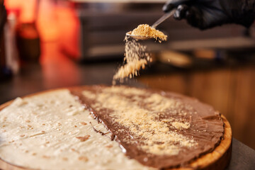 Close up of a hand putting stuffing in pancake.