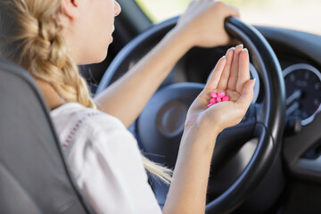 Fototapeta na wymiar woman holds tablets at the steering wheel while driving