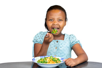 Little african girl eating healthy dish at table