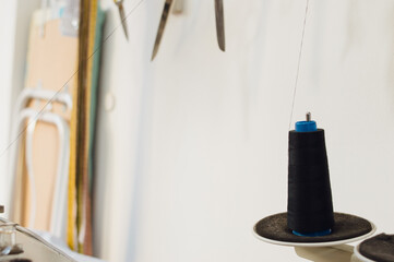 roll of black thread on a sewing machine, copy space.