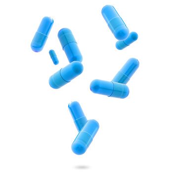 blue medical gel capsules falling down on white background. food supplement, pharmacy concept. plastick capsules pills