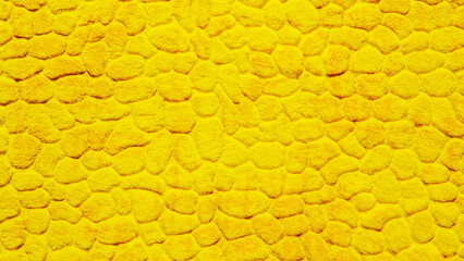 Yellow plush fabric texture, carpet pattern. Pile fabric with raised circles. Yellow background.	