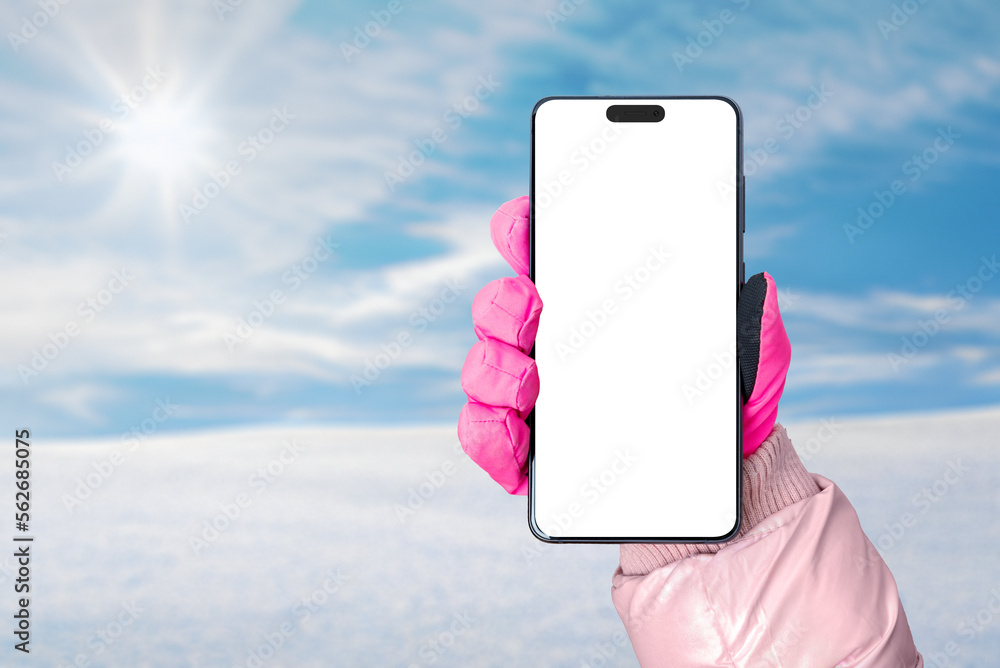 Poster phone mockup in hand with pink glove. snow and sun in the background. isolated display with camera f