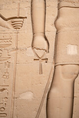 Hieroglyphics of a person holding a anj with the hand at temple Kom Ombo from Egypt
