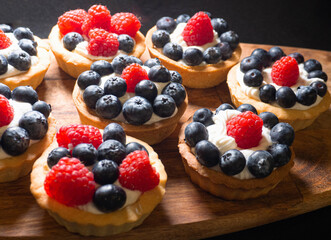 Freshly baked baskets with curd cream  and strawberries 