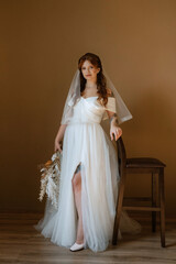 Fototapeta premium portrait of a bride girl with red hair in a white wedding dress