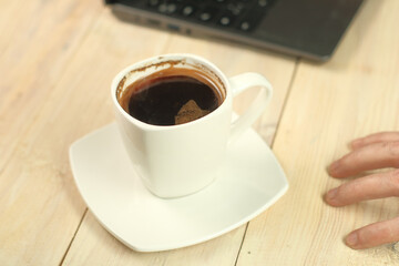 Obraz na płótnie Canvas a cup with coffee on a stand
