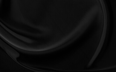 Black gray satin dark fabric texture luxurious shiny that is abstract silk cloth background with patterns soft waves blur beautiful.