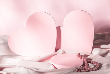 Composition for Valentine's Day or Wedding Day. Pink hearts on a pastel pink background, a...