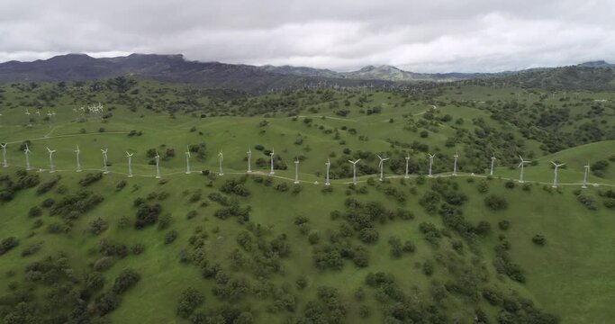 Windmills in Upper Cottonwood Creek Wildlife Area near Los Banos. California. USA. Mountains in Background