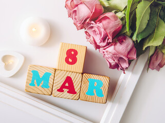 International Women's Day calendar greeting card background. With wooden heart, pastel color flower blossoms and text 8 march.
