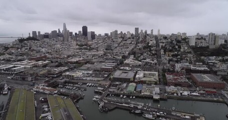 San Francisco Cityscape and Fisherman's Wharf in Background. Cloudy Day. Aquatic Park Pier, Cove and Municipal Pier in San Francisco. Maritime National Historic Park in Background. California
