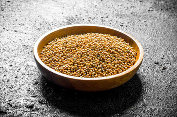Mustard in a wooden plate.