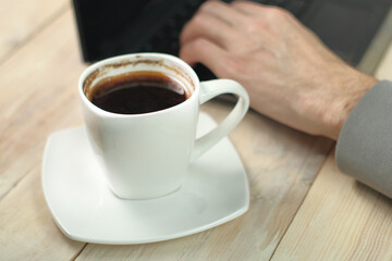 cup with coffee on the background of a laptop