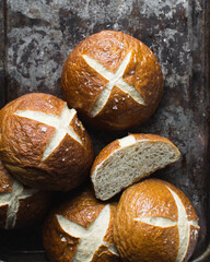 Top view of pretzel buns on an old baking sheet, German laugenbroetchen on a baking tray