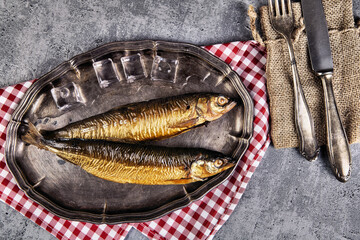 Smoked fish in a traditional way on a rustic background
