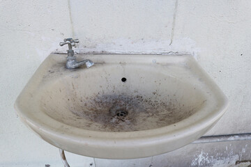 Dirty washbasin or sink in the bathroom.