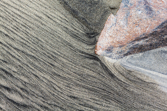 Patterns caused by sediment transport by water in the sand on Bunes Beach, Moskenesoya, Lofoten Islands, Norway.