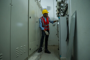 Engineer working in electrical control room,operator station network in industry factory,Switchgear.
