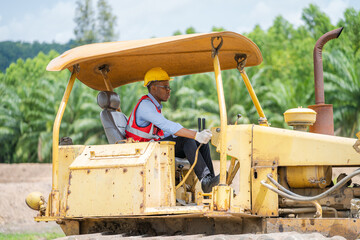 Professional construction industry driver,Construction worker are driving bulldozer at construction site. © visoot