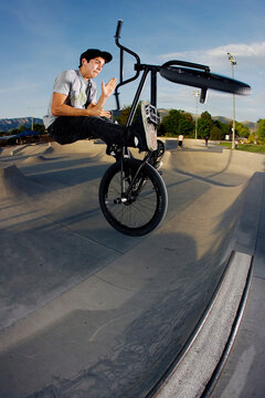 A BMX rider does a barspin on a quarter pipe at the Los Altos Skatepark.