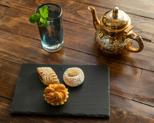 variety of biscuit over bowl an arabic teahouse. Accompanied with a chocolate cake