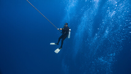 diving instructor waiting for his clients on the rope
