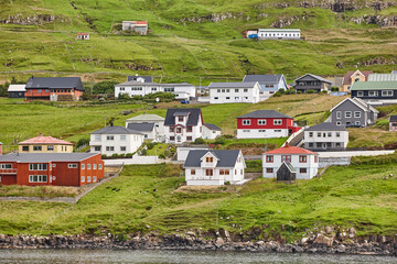 Naklejka premium Traditional faroese village in Suduroy island. Fjord landscape. Tvoroyri