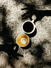 Image of cup of coffee. Coffee with milk and dark coffee. Game of shadows. Cappuccino and dark coffee