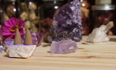 Obraz premium Amethyst Crystals With Flowers and Incense Cones on Meditation Table
