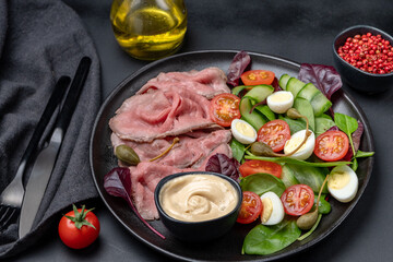 Roast beef with spinach salad and quail eggs healthy lunch keto diet food