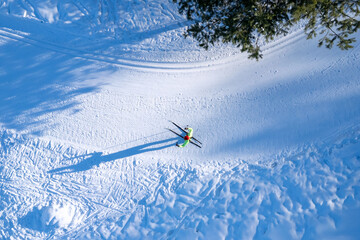 Skier cross-country skiing in snow forest. Winter competition, Aerial top view