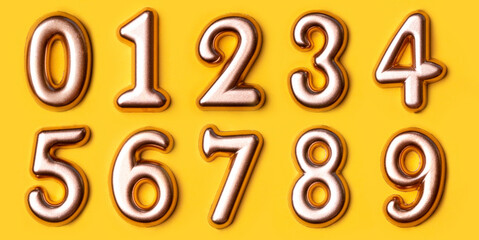 Metal numbers set on a yellow background. Top view.