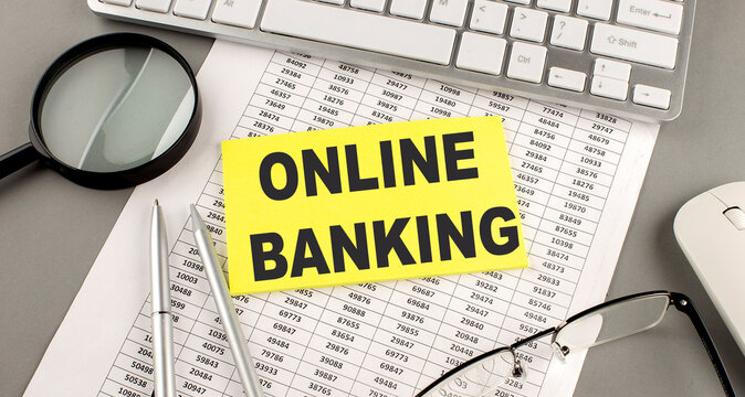 ONLINE BANKING text written on a sticky on chart with keyboard and magnifier