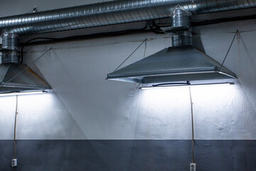 close-up of exhaust hoods in hazardous production, together with an air removal system, photographed immediately after installation work