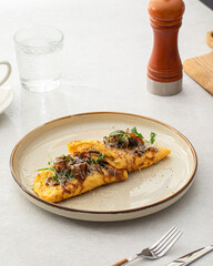 Portion of gourmet omelette with mushrooms and cheese