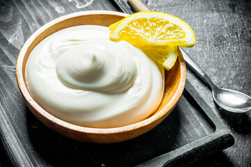 Mayonnaise on a cutting Board with lemon slices.