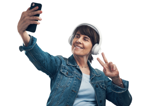 A senior woman taking selfies while wearing headphones Isolated on a PNG background.