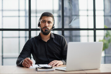 Business people wearing headset working in office broaden view