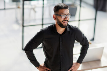 Portrait of smiling young businessman in office