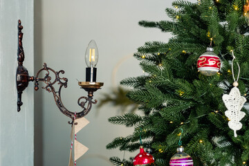 Candle-style lamp in a candelabra near the Christmas tree