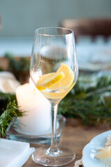 a glass of alcohol on the New Year's table. glass of cocktail with lemon in a glass