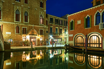 Fototapeta na wymiar Night view of the The Malcanton river (bad corner canal) is a canal of Venice that limits the sestiere of Santa Croce and Dorsoduro.