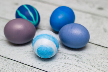 Blue Easter Eggs on old white wood background