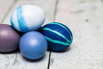 Blue Easter Eggs on old white wood background