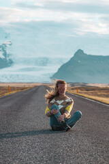 Road on Iceland, glacier, blond woman running, amazing view