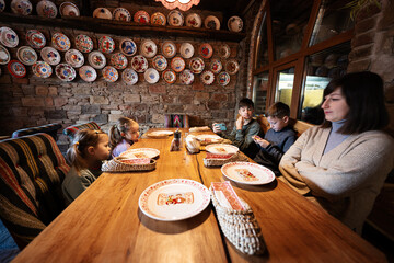 Family having a meal together in authentic ukrainian restaurant.